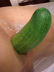 Asian boy putting fresh vegetable into own anal hole