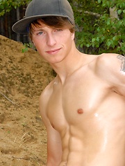 Nude skinny boy playing in the sand