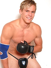 Youn naked kickboxer posing in his sport uniform