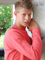 Sweet white-haired boy posing on the building