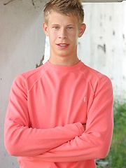 Sweet white-haired boy posing on the building