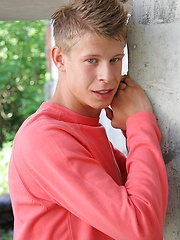 Sweet white-haired boy posing on the building