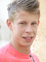 Sweet white-haired boy posing on the building